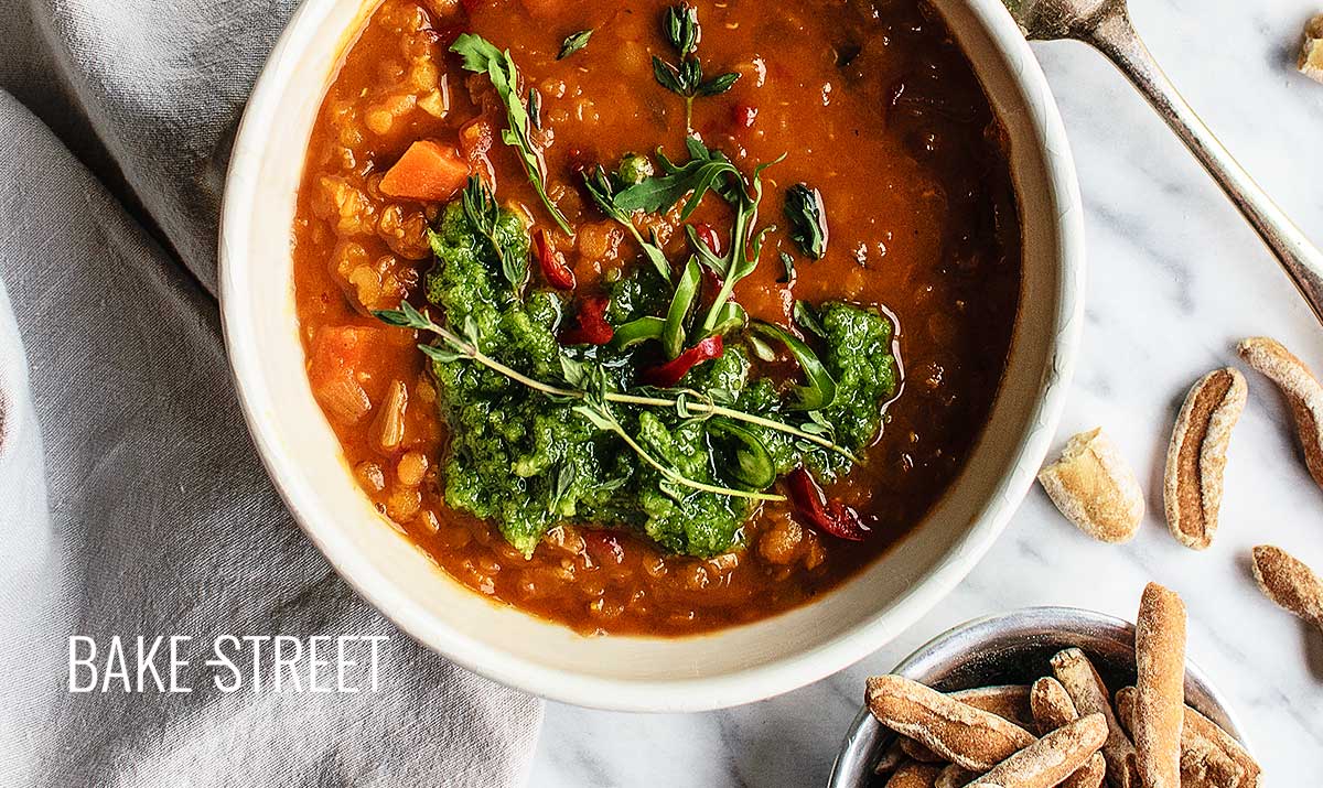 Spicy red lentils soup with arugula picada