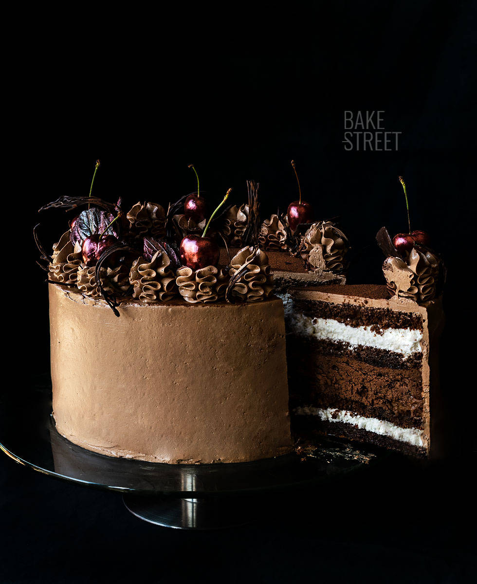 Bakery With Piece Of Unusual Yellow Mousse Cake With Almond Dacquoise  Raspberry Confit Crispy Layer With Caramelized Hazelnuts And Raspberry  Powder Mousse Based On Bitter Chocolate Served On Wooden Table Stock Photo -